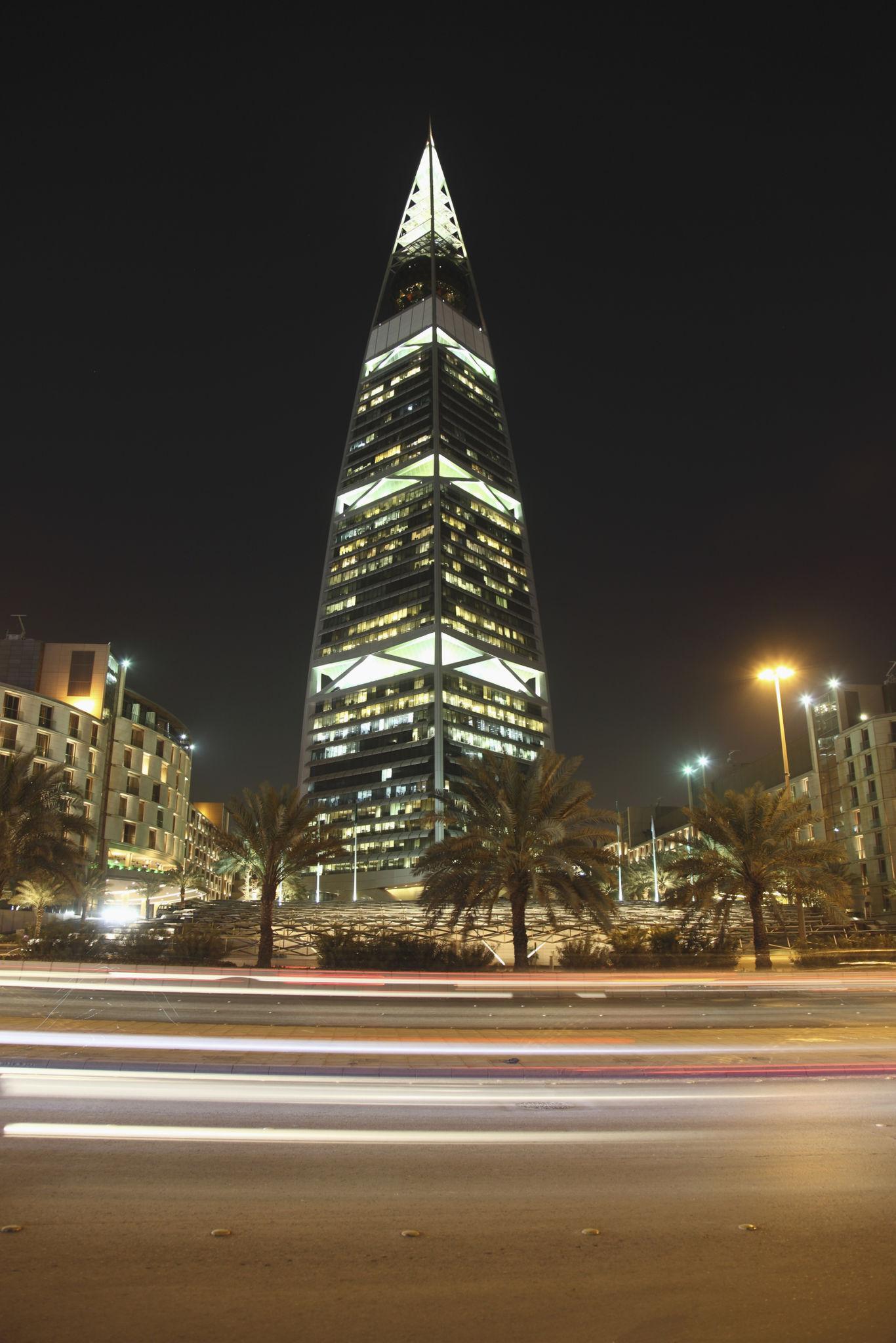Al Faisaliah tower illuminated against the night sky in Riyadh