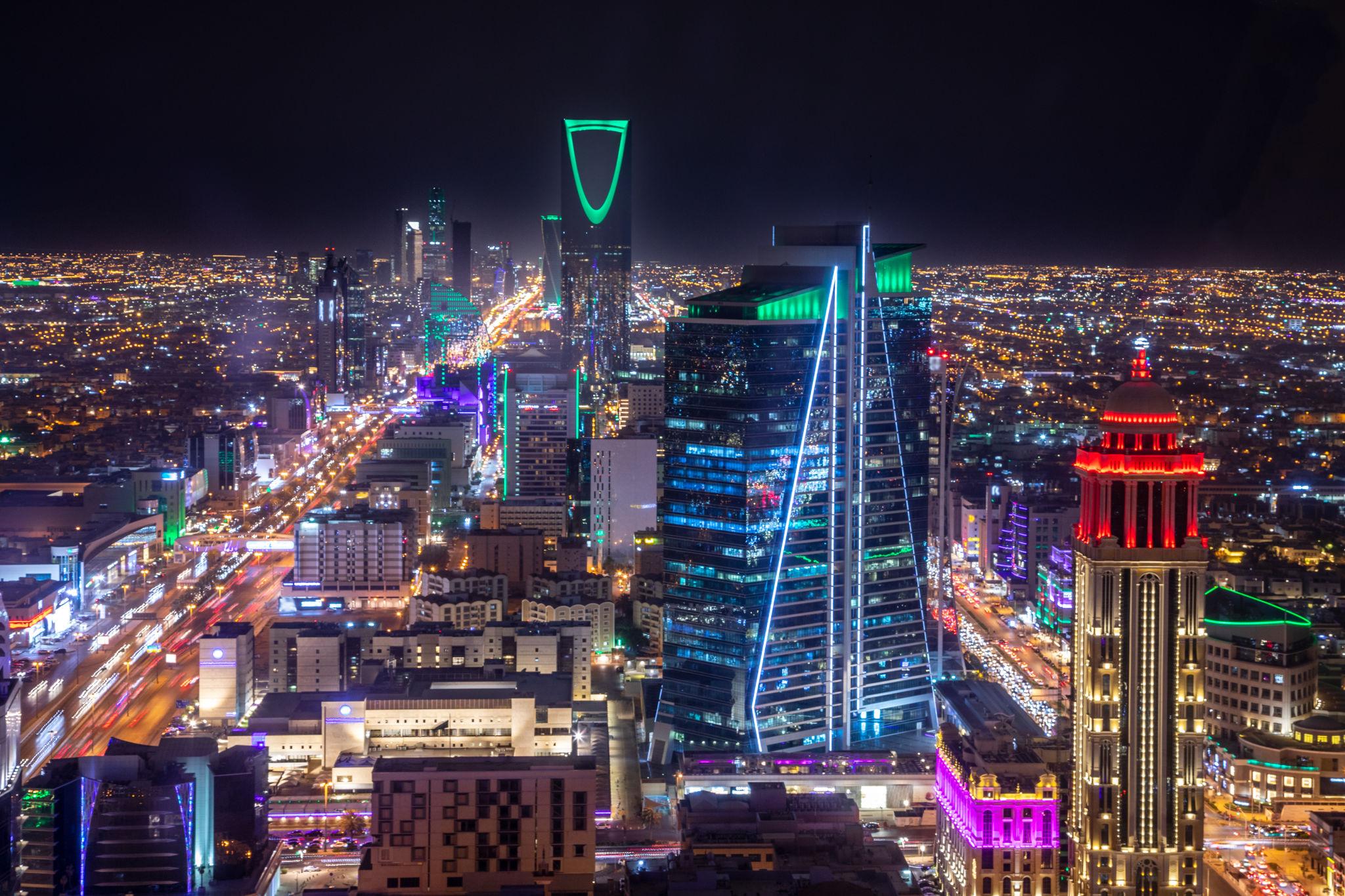 The Riyadh skyline at night, with Kingdom Centre lit green above the city